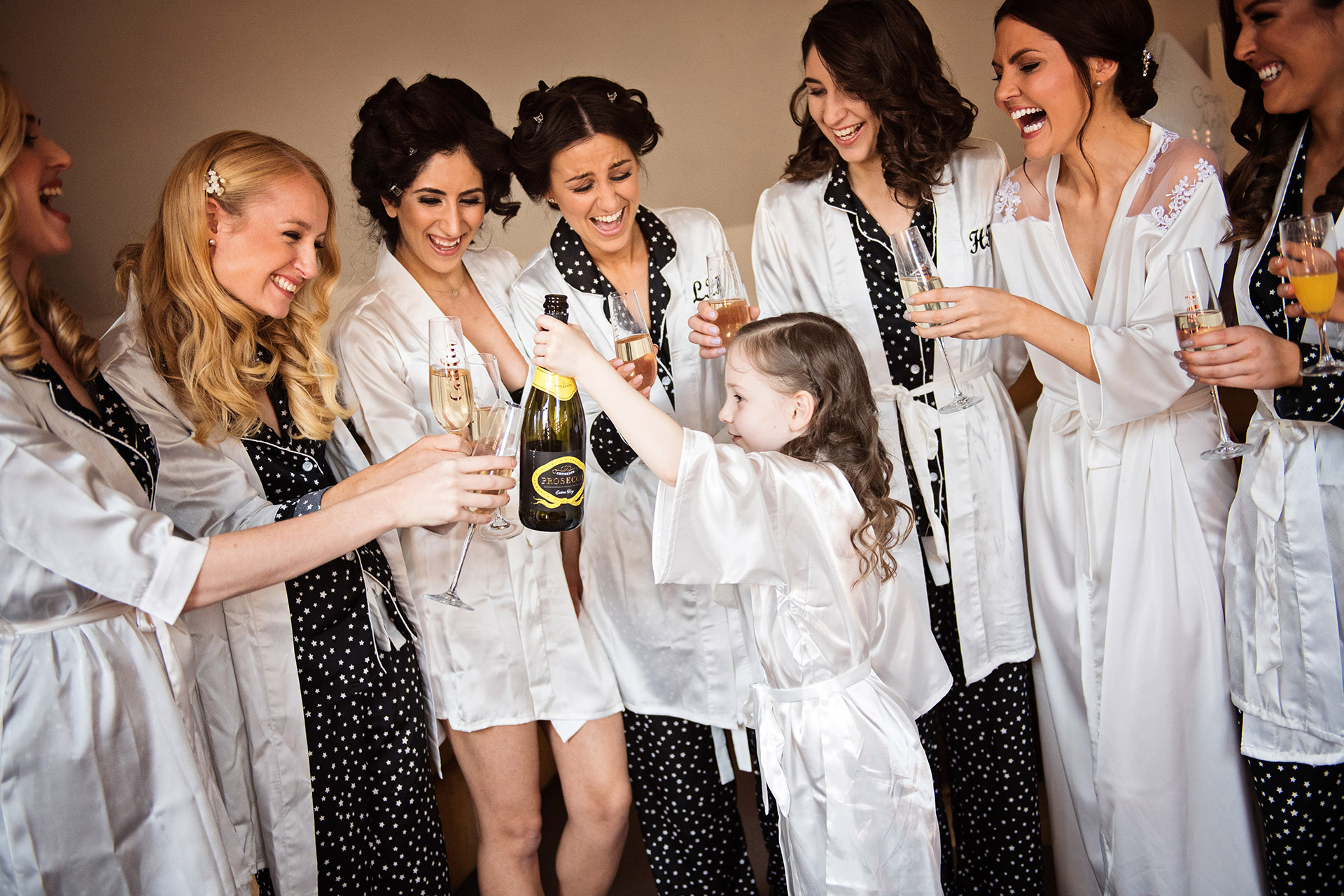 bride and bridesmaids with flower girl cheers