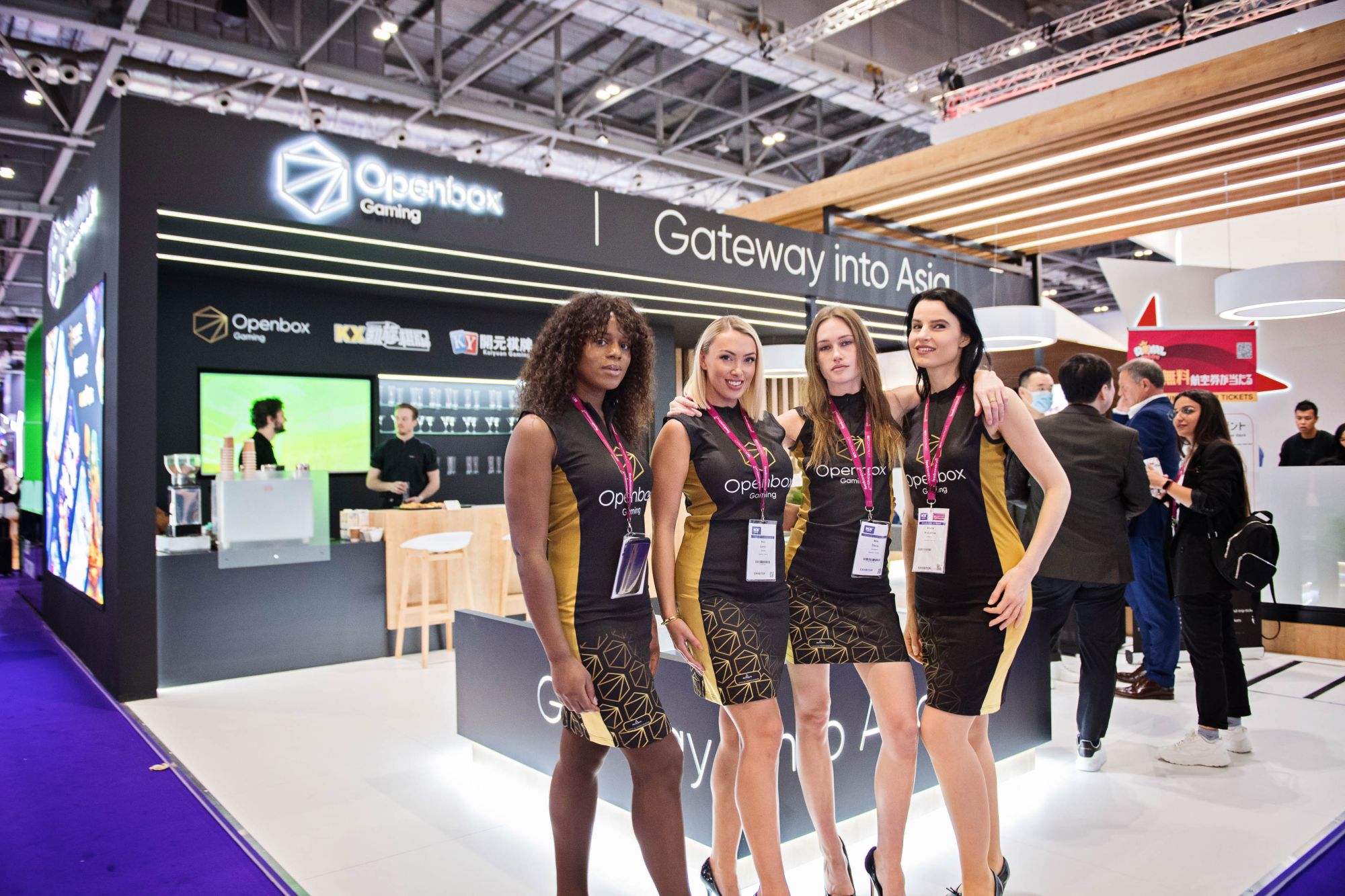 Models stand in front of Exhibition stand at the Excel London