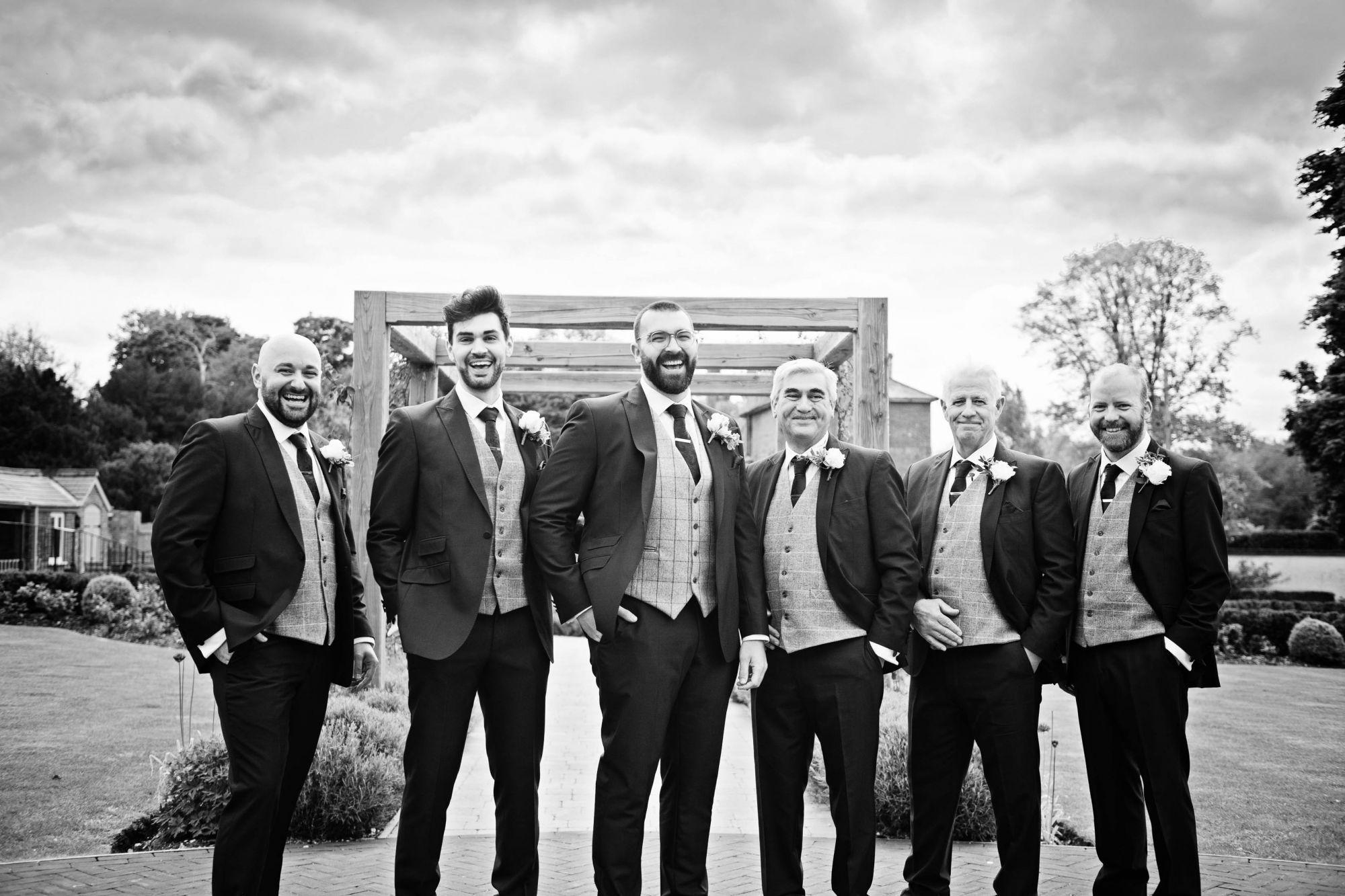 grooms men in a black and white image taken at Syrencote.