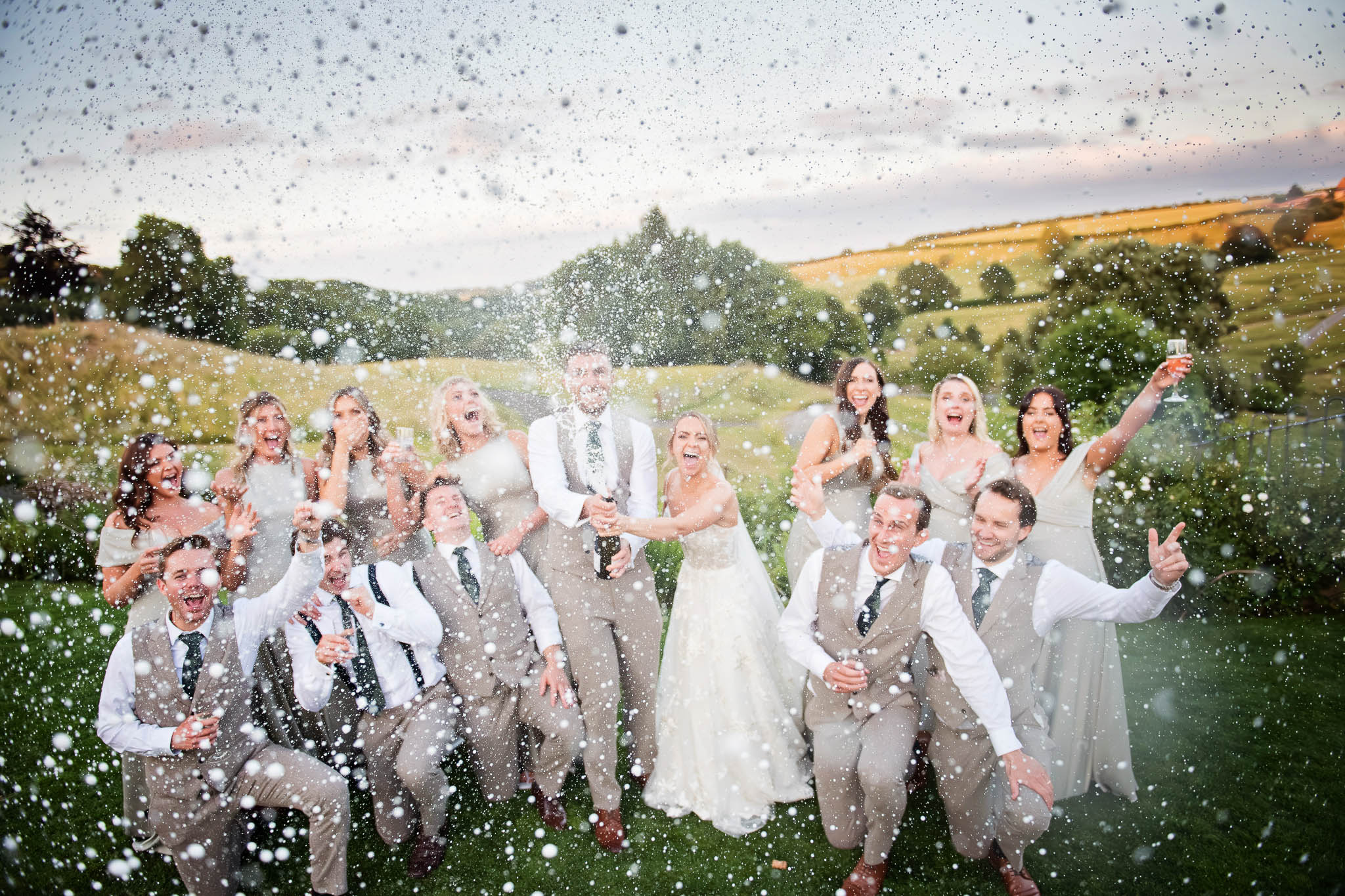 Bridal Party spray champagne in a wedding celebration