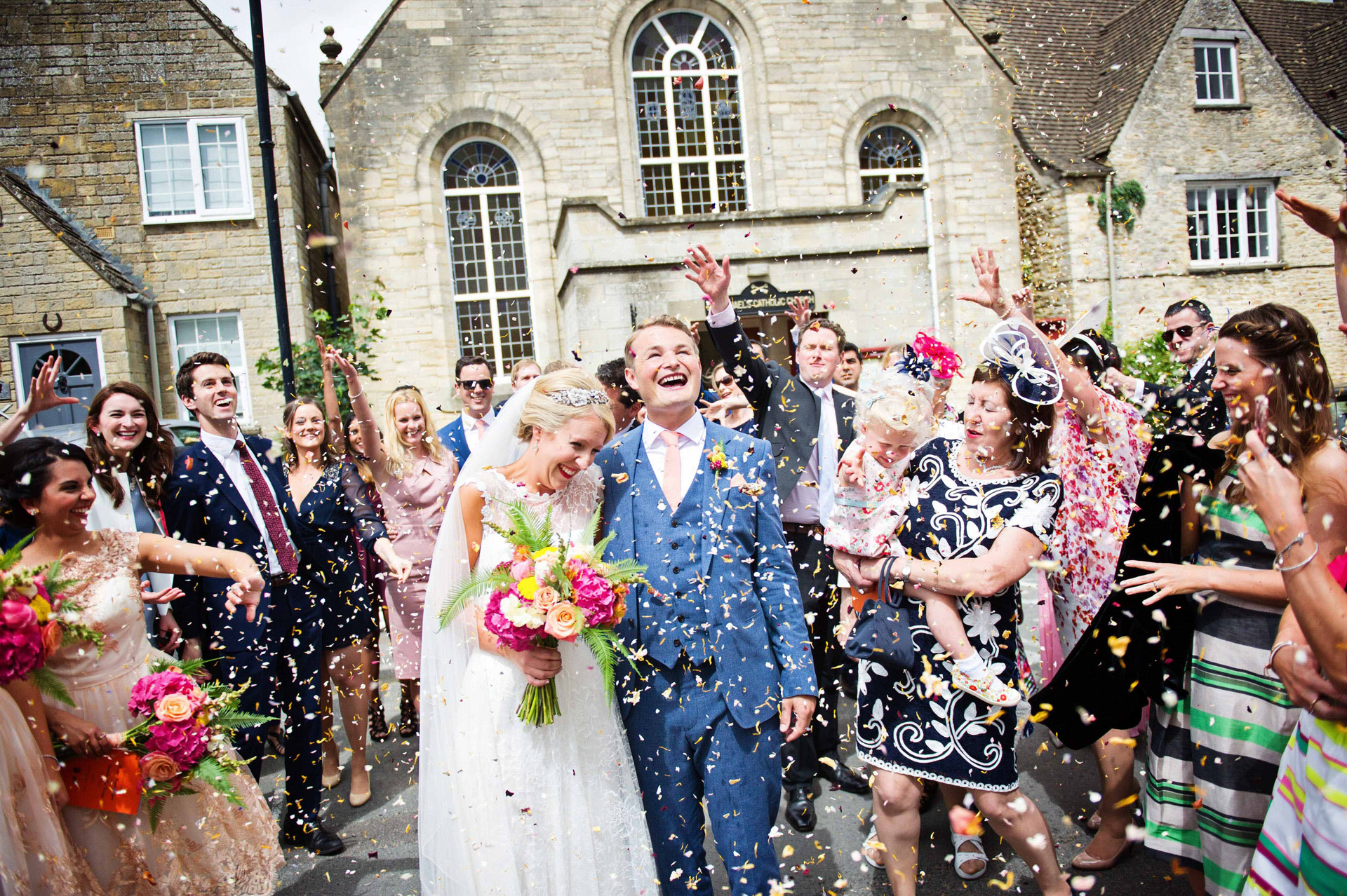 Wedding confetti, confetti, bride and groom celebration, wedding guests, Tetbury wedding, wedding photography in the cotswolds