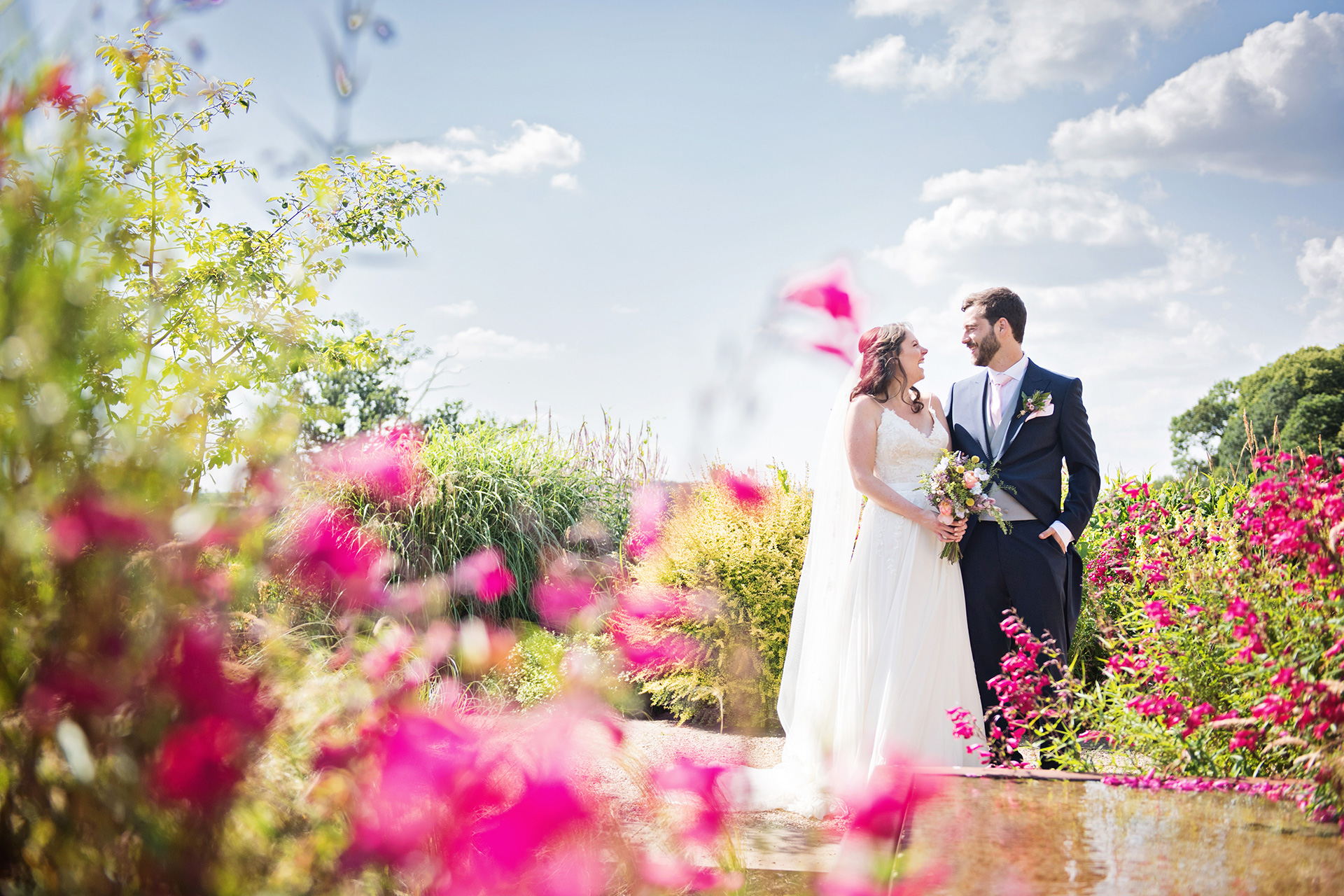 Bride and Groom in a gorgeous English garden setting. Taken at Hyde House)