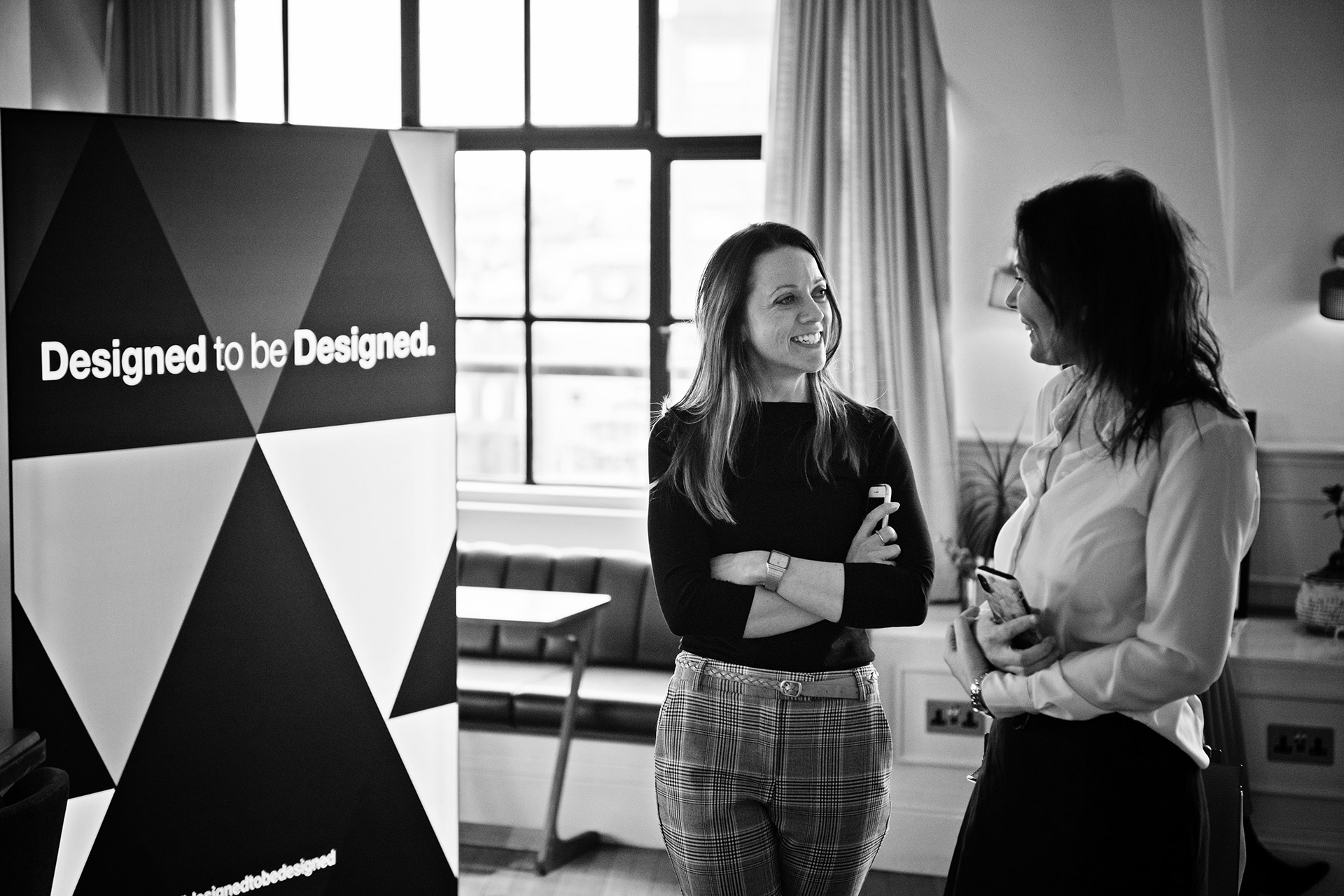 Two businesswomen chat at Kohler Designed to be Designed event at Mortimer House, London
