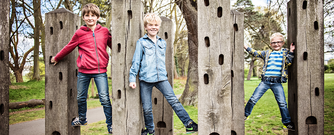 boys having fun climbing on a family photoshoot