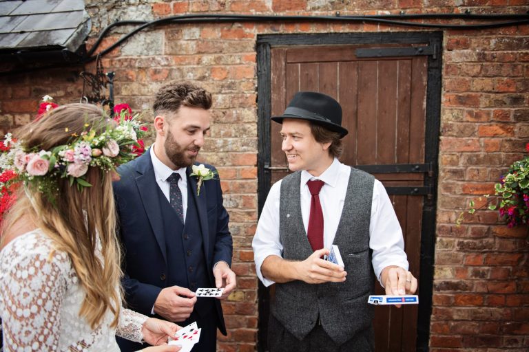 Magician Darren Campbell doing his magic trick to bride and groom at Overbarn, Gloucester.