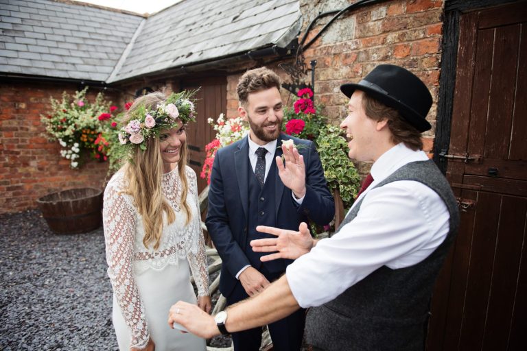Magician Darren Campbell doing his magic trick to bride and groom at Overbarn, Gloucester.