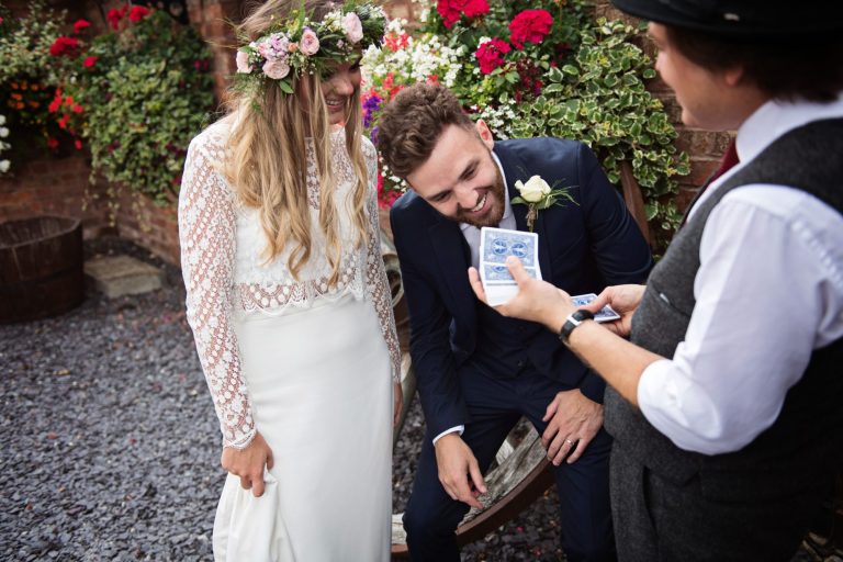 Magician Darren Campbell doing his magic trick to bride and groom at Overbarn, Gloucester.