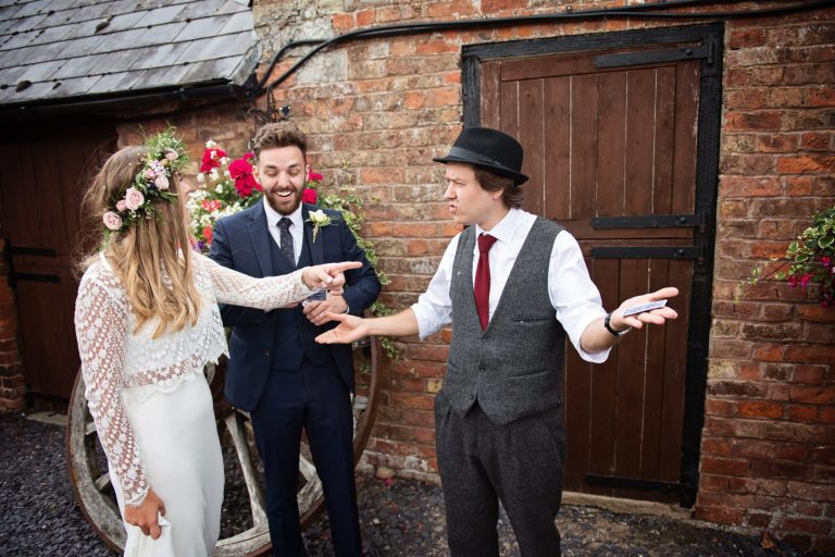 Magician Darren Campbell doing his magic trick to bride and groom at Overbarn, Gloucester.