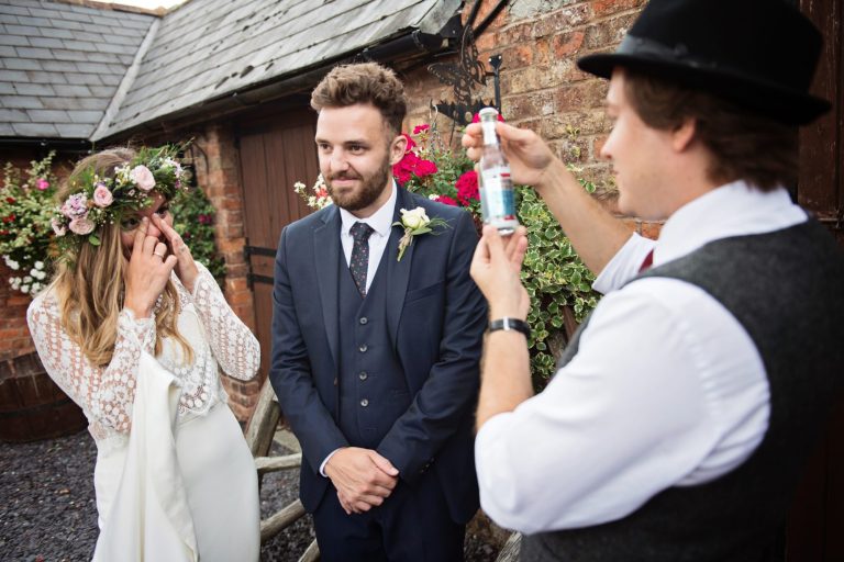 Magician Darren Campbell doing his magic trick to bride and groom at Overbarn, Gloucester.