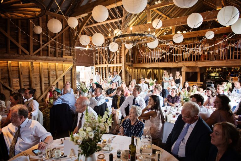 Overview of the Overbarn Barn as wedding guests listen to the speeches.