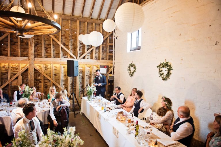 Best man delivers his speech at Overbarn, Gloucester. Barn is gorgeously decorated in a rustic theme.