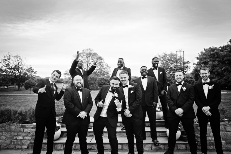 B & W image of groom and his groomsmen line up in wait for the bride at Blackwell Grange.