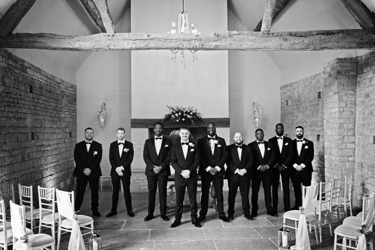 B & w image groom and his groomsmen line up in wait for the bride at Blackwell Grange.