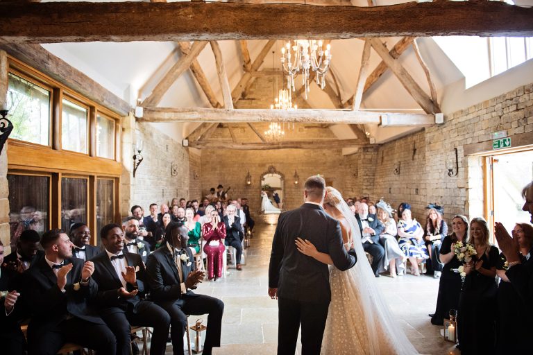 Bride and groom getting a lot of love from their wedding guests. Candid photo by Blooming Photography taken at Blackwell Grange.