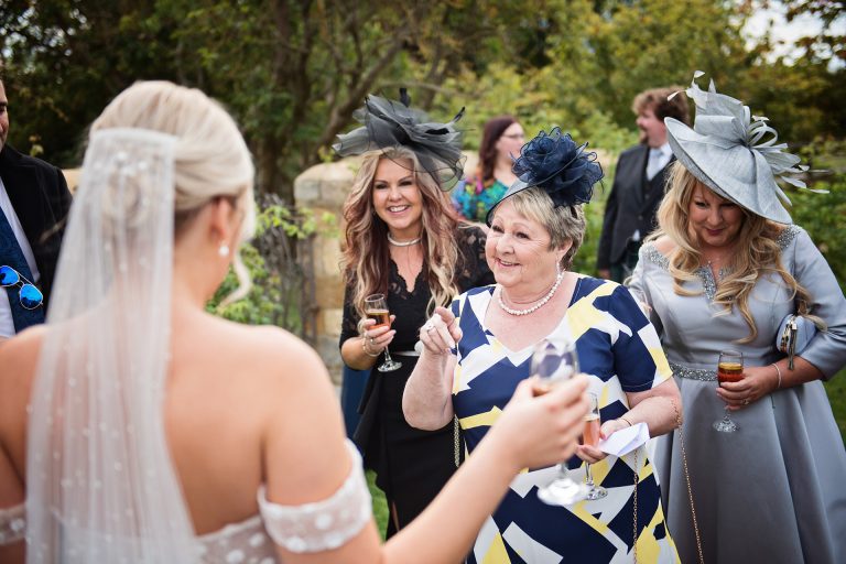 Candid photo by Blooming Photography taken at Blackwell Grange. An auntie pointing at the bride in celebration.