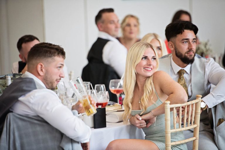 Natural photo taken of wedding guests, during the wedding speeches.