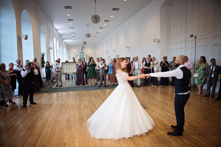 Colour photo of bride and groom doing their first dance in the Orangery.