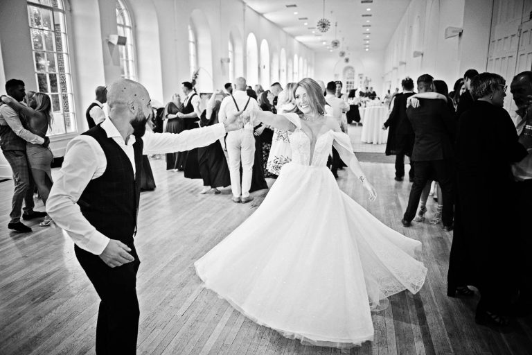 B&W photo of bride and groom dancing