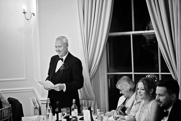 B&W photo of brides father doing his speech.