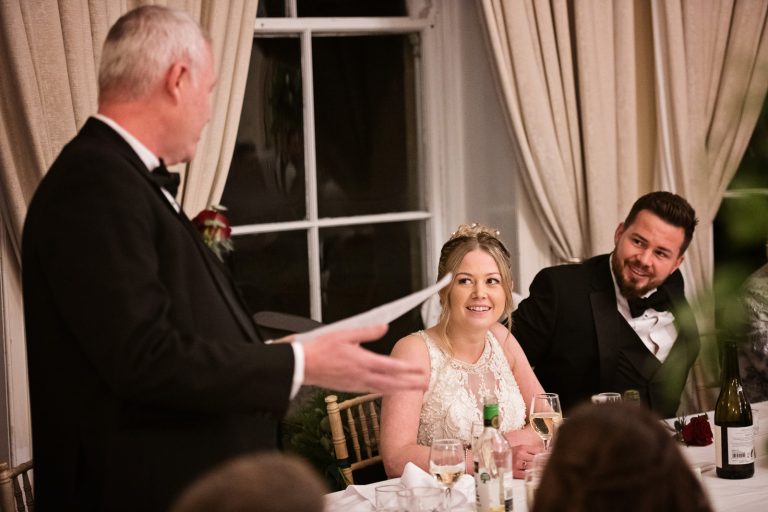 Brides father delivering his speech to the bride and groom. Photograph by Blooming Photography taken at Eastington Park at Christmas Wedding.