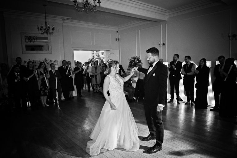 Bride and groom at the first dance, black and white photo. Taken at Eastington Park at Christmas Wedding. Photograph by Blooming Photography.
