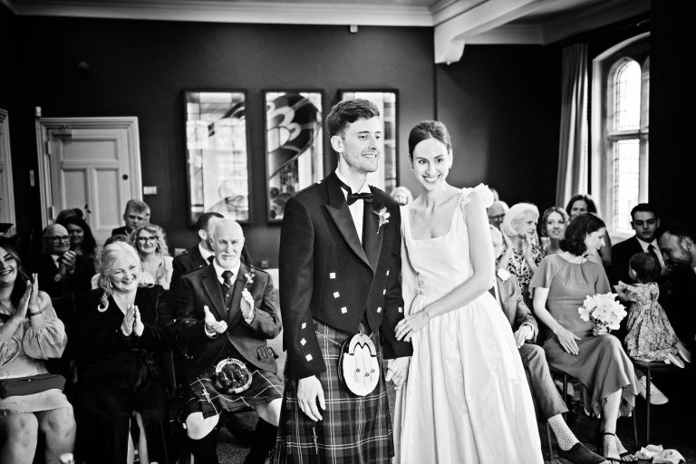 Natural Documentary b&w wedding photography at Winchester registry office. Photo by Blooming Photography