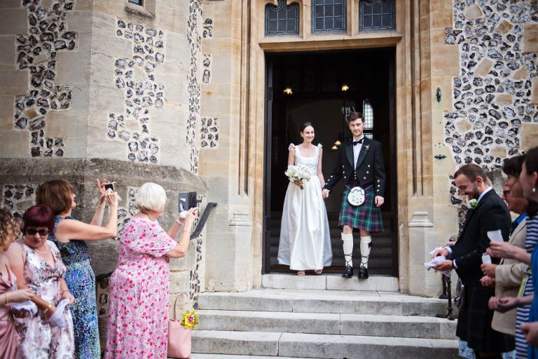 Bride and groom leaving Winchester Registry Office, Photo by Blooming Photography