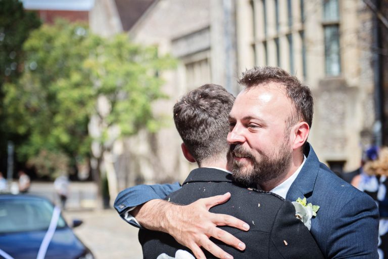 Unposed, candid, natural moments outside Winchester Registry office. Photography by Blooming Photography