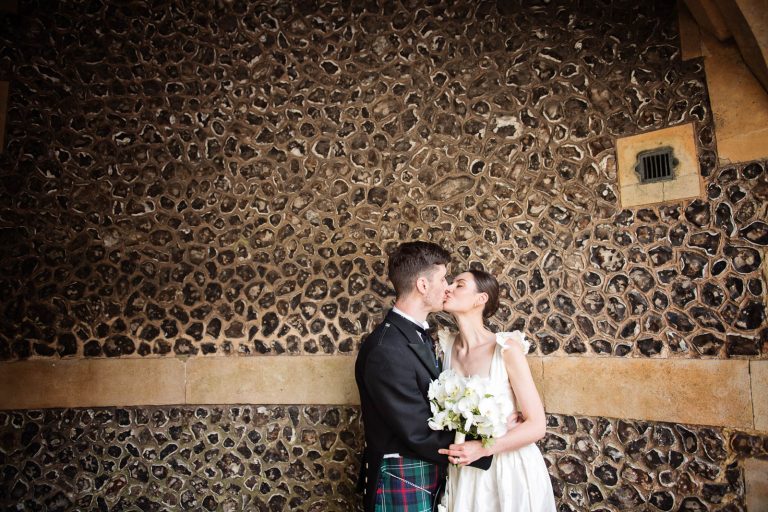 Candid wedding photo of bride and groom kissing in Winchester, photo by Blooming Photography.