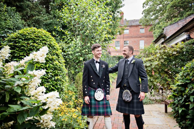 Two men in kilts in the grounds of Hotel Du Vin Winchester at a Wedding, photo by Blooming Photography