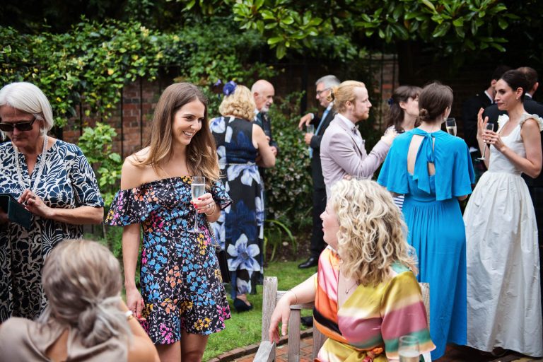 Storytelling wedding photo of guests talking at Hotel Du Vin Winchester, photo by Blooming Photography