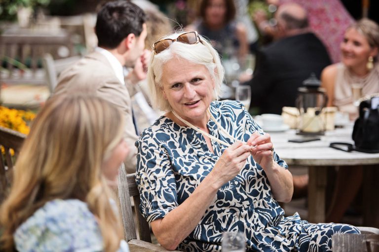 Documentary wedding photo of guests chatting at Hotel Du Vin Winchester, photo by Blooming Photography