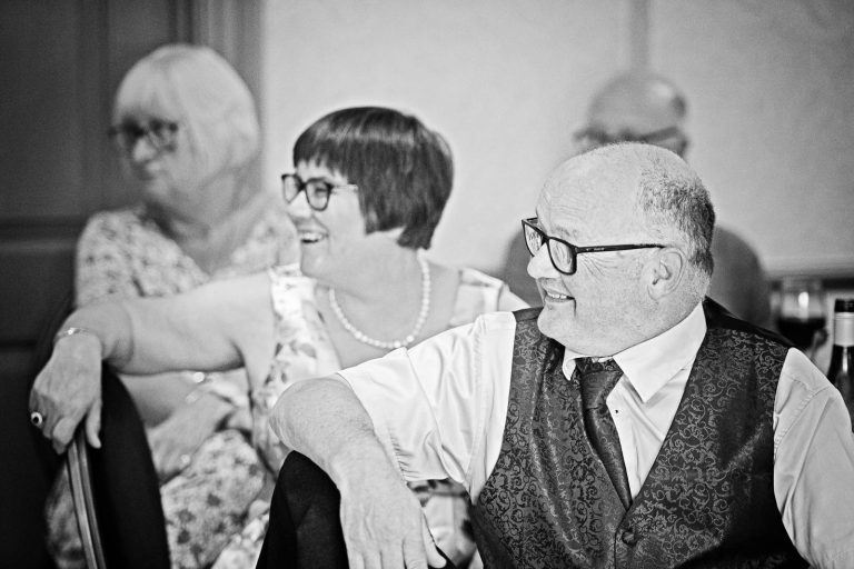 Wedding guests laughing at speeches at Hotel du Vin, Winchester. Photo by Blooming Photography