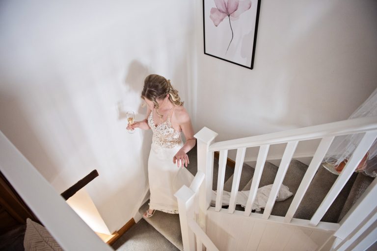 Bride walks down the stairs.
