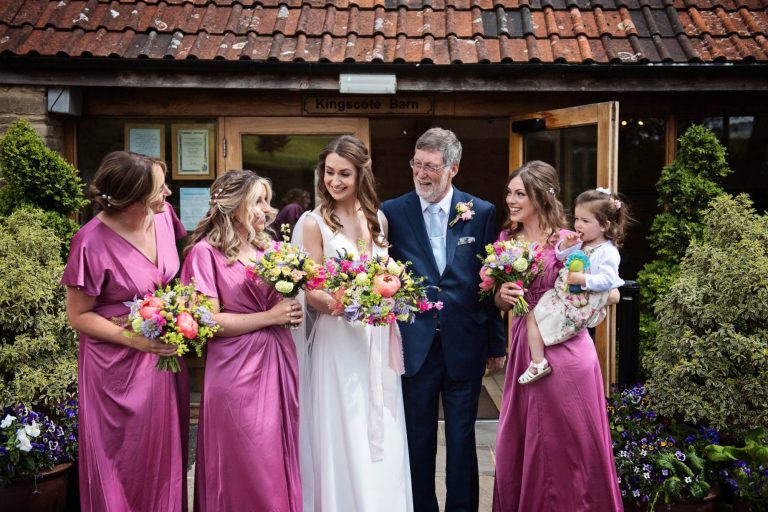 Candid photo of team bride at Kingscote Barn