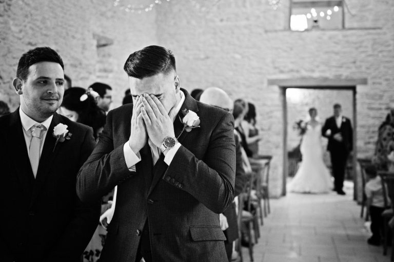 Emotional groom at Kingscote Barn wedding.