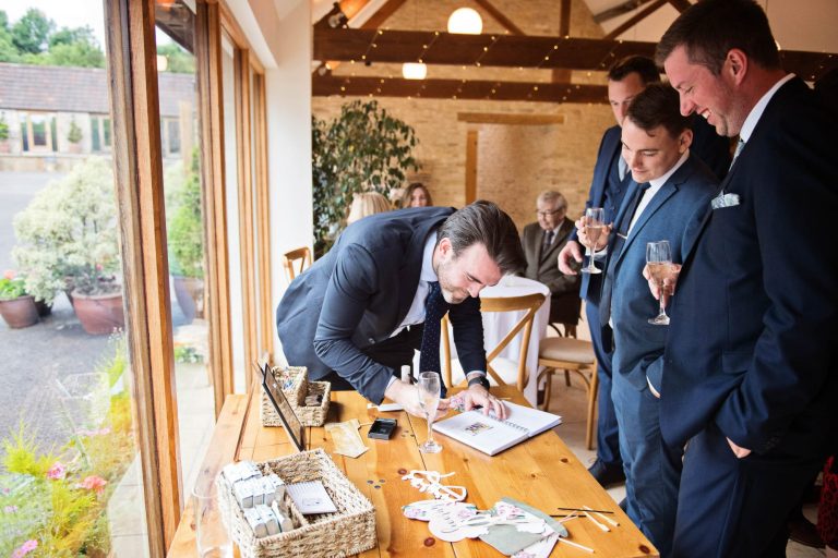 Candid photo at Cotswold wedding at Kingscote Barn.