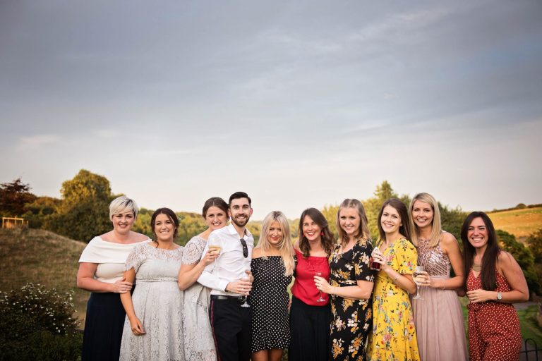 Fun posed wedding photo of guests at Cotswold wedding venue, Kingscote Barn