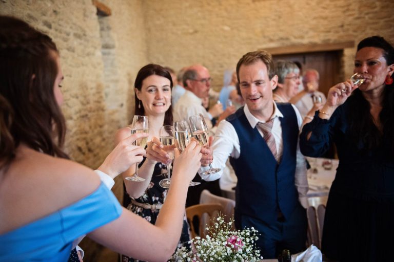 Candid photo of guests celebrating at Kingscote Barn