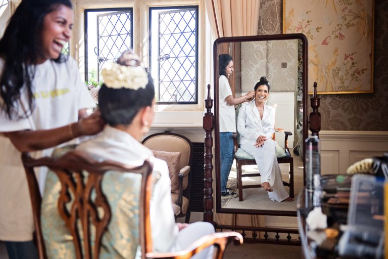 Bride's hair photographed in the mirror at North Mymms Park, by Blooming Photography