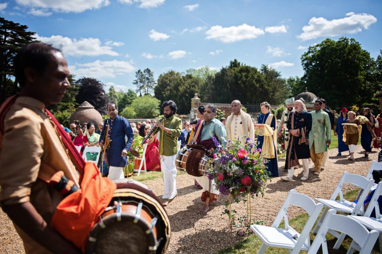 Grooms family and musicians arrival at North Mymms Park, candidly photographed by Blooming Photography.