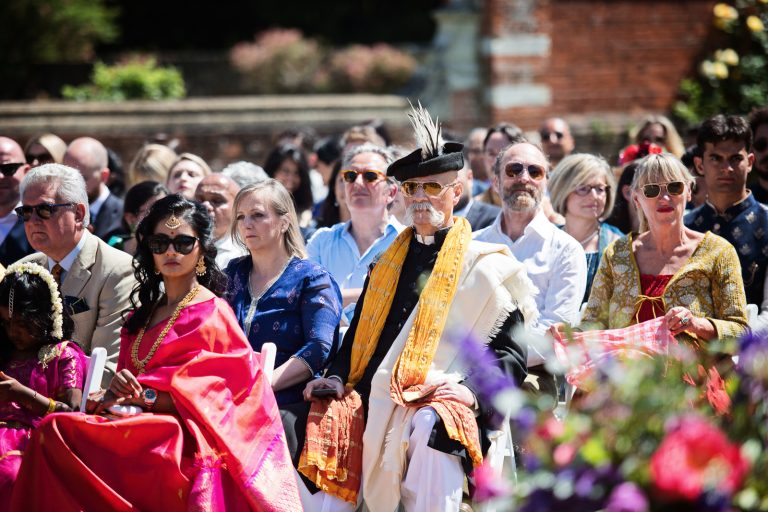 Wedding guests looking fabulous in Indian wedding attire at Hindu ceremony at North Mymms Park, candidly photographed by Blooming Photography.