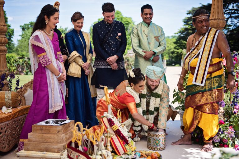 Finding the ring game during Hindu ceremony at North Mymms Park, candidly photographed by Blooming Photography.