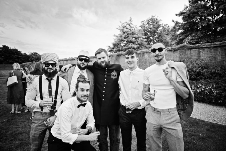 Guest posing for a photo. Black and white photo. Photographed at North Mymms Park, by Blooming Photography.