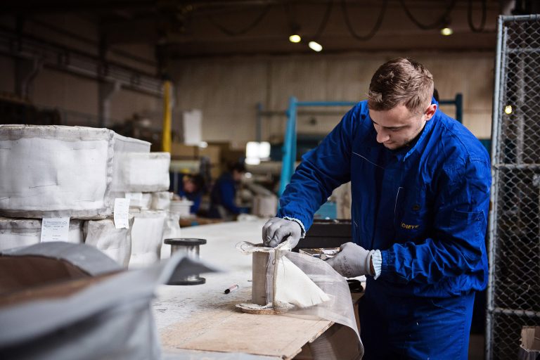 A worker creating an expansion joint in a engineering factory in Romania.