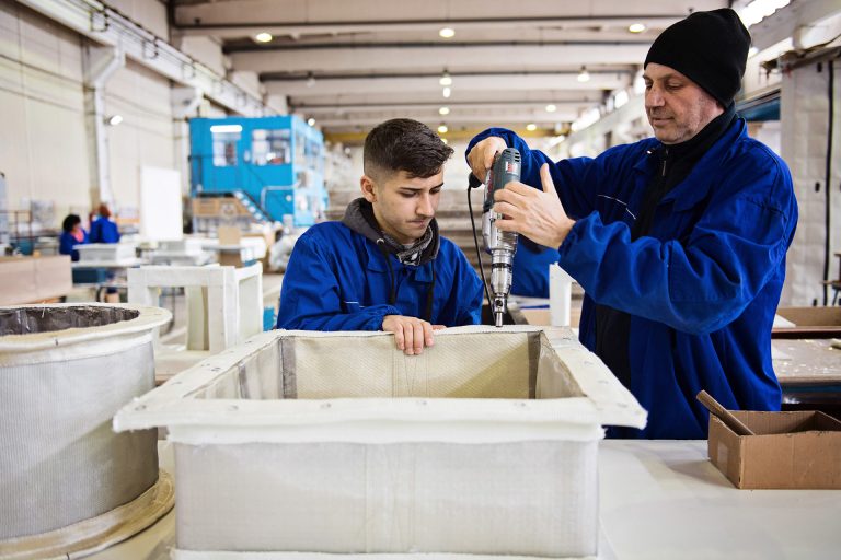 Two colleagues work together to create an expansion joint. Engineering.