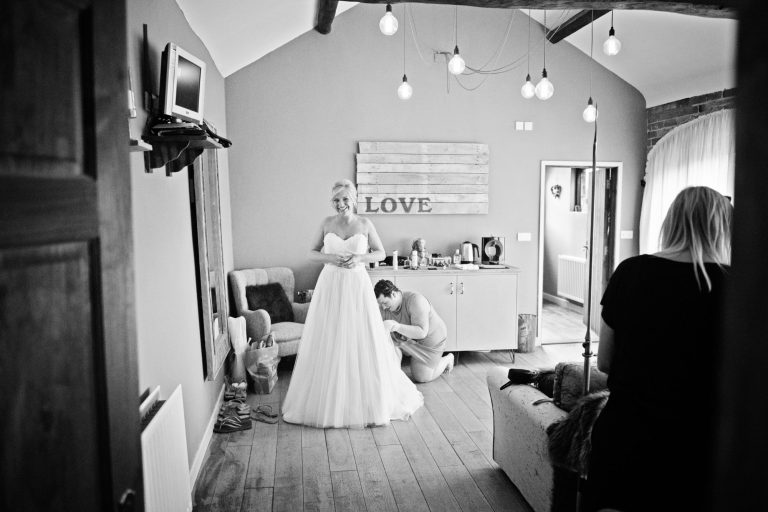 B&W photo of bride getting ready.