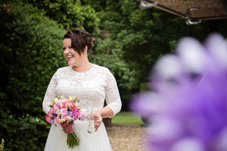 Informal photo of bride smiling before the wedding ceremony.