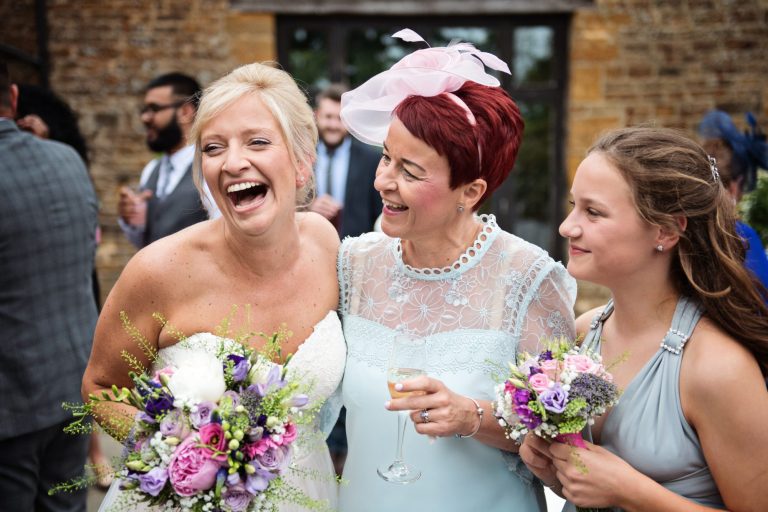 Candid photograph of guests smiling and laughing.