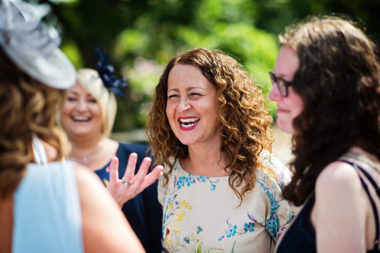 Candid photograph of guests smiling and laughing.